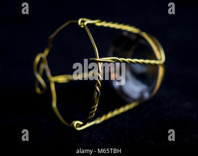 Muselet from bottle of champagne. Isolated on black background. Selective focus. Macro Stock Photo