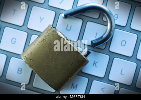 top view computer protection security concept with broken padlock on white button keyboard Stock Photo