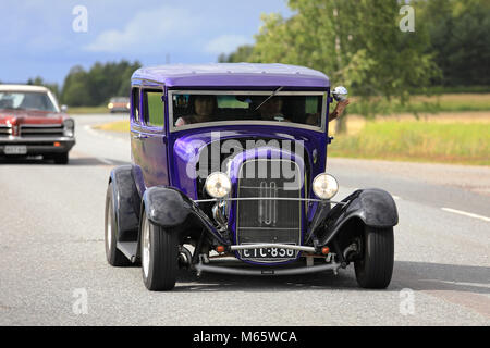 SOMERO, FINLAND - AUGUST 5, 2017: Purple classic Hot Rod Ford car moves along rural highway on Maisemaruise 2017 car cruise in Tawastia Proper, Finlan Stock Photo