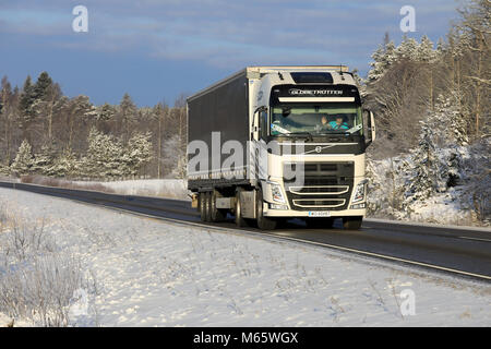 SALO, FINLAND - JANUARY 19, 2018: White Volvo FH500 semi trailer on the road on a beautiful day of winter. The driver in Globetrotter XL cab waves in  Stock Photo