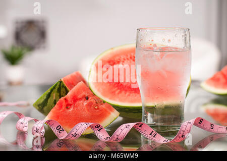 Cup of water and watermelon on table, diet concept Stock Photo