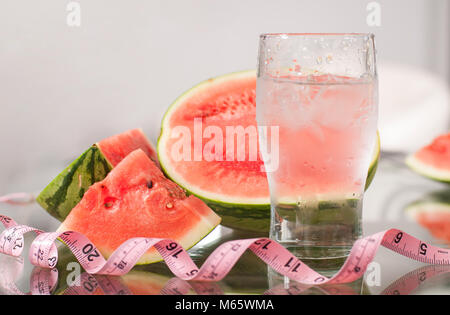 Cup of water and watermelon on table, diet concept Stock Photo