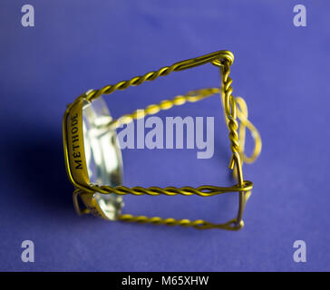 Muselet from bottle of champagne. Isolated on blue background. Selective focus Stock Photo