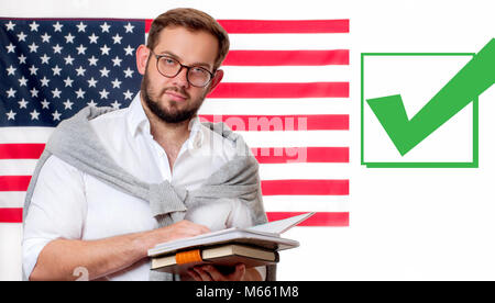 Smiling young man on United States flag background.  American flag and check mark Stock Photo