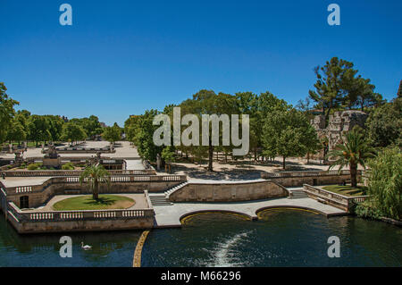 View of the 18th-century Gardens of the Fountain, built around the Roman Thermae ruins at Nimes. Located in the Occitanie region in southern France. Stock Photo