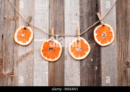 Fresh Citrus Fruits. Pieces grapefruit on wood background. Stock Photo