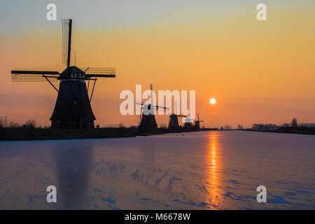 Sunrise on a cold winter day at the windmills at world heritage site Kinderdijk in the Netherlands Stock Photo