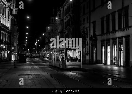 Graz, Austria - 08.02.2018: Tram going down the deserted Herrengasse towards Jakomini station at night (black / white)) Stock Photo