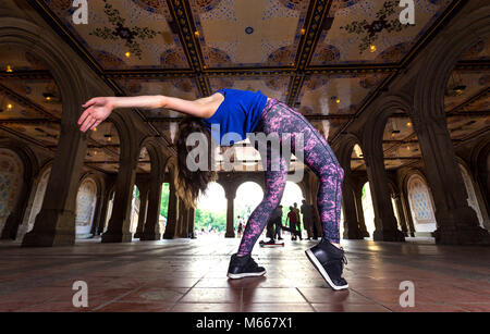 Young Caucasian Brunette Woman Performs Hip Hop Dance Wearing Leisurewear Under The Minton Tiles at Bethesda Arcade Stock Photo