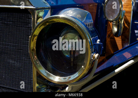 An original brass rimmed headlamp installed on a vintage car Stock Photo