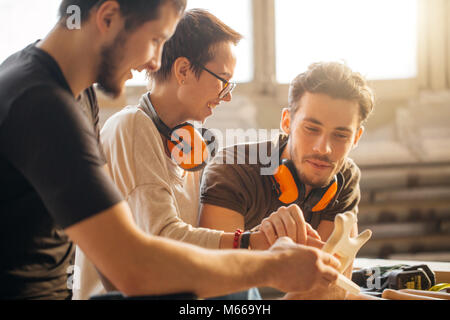 carpenter with students in woodworking workshop Stock Photo
