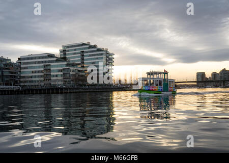 Downtown Vancouver, British Columbia, Canada - January 28, 2017 - A small taxi ferry boat is riding in False Creek during a vibrant winter sunset. Stock Photo