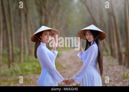 Two women holding hands, Vietnam Stock Photo