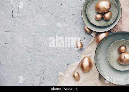 Golden eggs in ceramic bowls Stock Photo