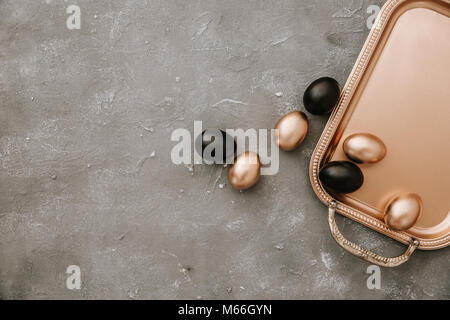 Gold and black Easter eggs on a gold tray Stock Photo