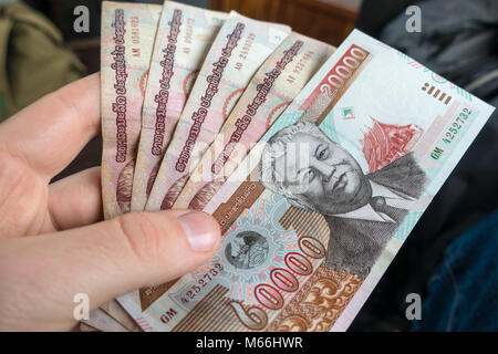 Mans hand holding Laos money, kip banknotes close up Stock Photo