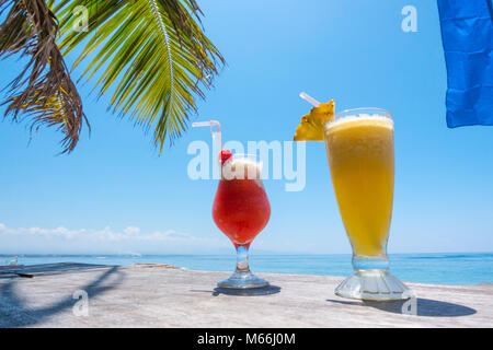Two exotic cocktails on the table on tropical beach in Thailand Stock Photo