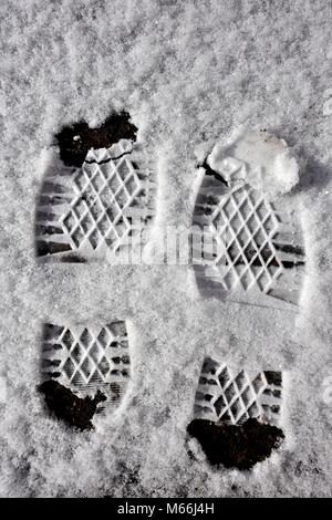 Two boot prints footprints in the snow Stock Photo