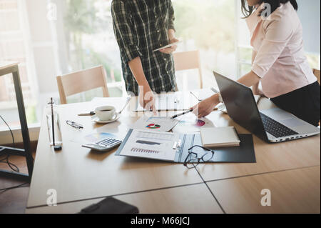 Asian businesswoman discussing and brainstorm with young freelance man in meeting room. Business company co-operate with outsource worker concept. Stock Photo