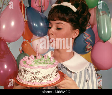 1960s TEENAGE GIRL BLOWING OUT THE CANDLE ON BIRTHDAY CAKE - kf4330 HAR001 HARS JOY LIFESTYLE CELEBRATION FEMALES STUDIO SHOT CAKES ONE PERSON ONLY HOME LIFE LADIES ADOLESCENT TEENAGE GIRL INDOORS NOSTALGIA 13-15 YEARS 16-17 YEARS BRUNETTE HAPPINESS HEAD AND SHOULDERS STYLES EXCITEMENT HAIRSTYLE PARTIES FASHIONS NOURISHMENT TEENAGED HAIRDO JUVENILES BANGS BEEHIVE HAIR BIG HAIR BOUFFANT CAUCASIAN ETHNICITY HAIR BAND HAIR BOW OLD FASHIONED PASTELS PERSONS Stock Photo