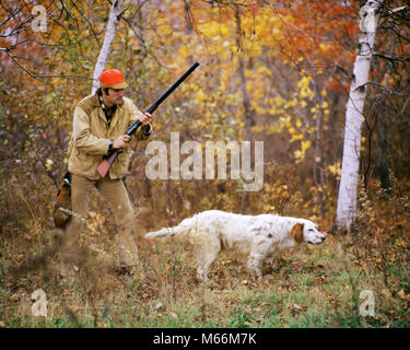 1960s 1970s MAN HUNTER WITH SHOTGUN IN AUTUMN LANDSCAPE PHEASANT HUNTING WITH ENGLISH SETTER GUN DOG ON POINT - kg6133 PHT001 HARS RURAL GROWNUP ONE PERSON ONLY COPY SPACE FULL-LENGTH HALF-LENGTH PHYSICAL FITNESS SCENIC GROWN-UP ANIMALS HUNTER NOSTALGIA HUNT 25-30 YEARS 30-35 YEARS FREEDOM PEOPLE STORY WING HAPPINESS PHEASANT TWO ANIMALS MAMMALS ADVENTURE LEISURE RELAXATION CANINES CHOICE EXCITEMENT POWERFUL RECREATION FALL SEASON OPPORTUNITY POOCH ENGLISH SETTER MOTION BLUR VERTEBRATE WARM-BLOODED PHASIANUS COLCHICUS OSHA ORANGE SAFETY ORANGE VIVID ORANGE AIMING BIRDS CANINE CREATURE Stock Photo