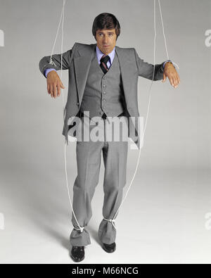 Puppeteer Holds The Puppet Business Man On The Ropes Stock Photo, Picture  and Royalty Free Image. Image 28107184.