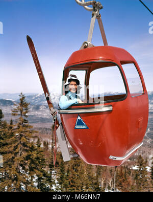 1960s SMILING WOMAN SKIER SITTING IN SKI LIFT GONDOLA LOOKING AT CAMERA SUGARLOAF MAINE USA - kw3405 HAR001 HARS EYE CONTACT 20-25 YEARS HEAD AND SHOULDERS ADVENTURE RELAXATION CHOICE EXCITEMENT RECREATION GONDOLA YOUNG ADULT WOMAN AERIAL LIFT CAUCASIAN ETHNICITY LOOKING AT CAMERA OLD FASHIONED PERSONS SKI LIFT SUGARLOAF Stock Photo