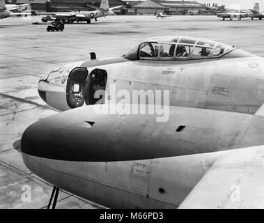 1950s FRONT OF JET AIRPLANE SLIDING COCKPIT FORWARD GUN BAY WITH DOOR OPEN ON TARMAC AT LANGLEY AIR FORCE BASE HAMPTON VA USA - q74717 CPC001 HARS UNITED STATES COPY SPACE II FORCE TRANSPORTATION NOSTALGIA NORTH AMERICA HISTORIC NORTH AMERICAN STRUCTURE ARCHITECTURAL ADVENTURE JET COURAGE BASE EXCITEMENT NOBODY SLIDING SOUTHEAST TARMAC WORLD WAR WORLD WAR II SOUTHERN COCKPIT COMMONWEALTH EAST COAST MOBILITY ARCHITECTURE DETAIL SMALL GROUP OF OBJECTS ARCHITECTURAL DETAIL CONFLICTING MALES VA B&W BATTLING BLACK AND WHITE COPILOT GUN BAY HAMPTON LANGLEY OLD FASHIONED PERSONS Stock Photo