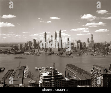 1940s 1950s NYC DOWNTOWN NEW YORK CITY SKYLINE ACROSS EAST RIVER FROM BROOKLYN - r4161 HAR001 HARS B&W BIG APPLE BLACK AND WHITE BROOKLYN DOCKS DOCKYARD EAST RIVER FINANCIAL DISTRICT OCCUPATIONS OLD FASHIONED PIERS SKYSCRAPERS Stock Photo