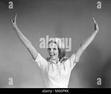 1960s PORTRAIT SMILING HAPPY BLOND WOMAN STRETCHING ARMS OUT AND UP ABOVE HEAD LOOKING AT CAMERA - s16194 HAR001 HARS SUCCESS HAPPINESS CHEERFUL VICTORY EXCITEMENT SMILES JOYFUL MID-ADULT MID-ADULT WOMAN B&W BLACK AND WHITE CAUCASIAN ETHNICITY LOOKING AT CAMERA OLD FASHIONED PERSONS Stock Photo
