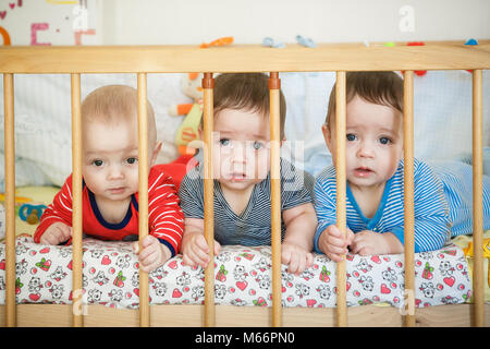 Portrait of  newborn triplets in the bed Stock Photo