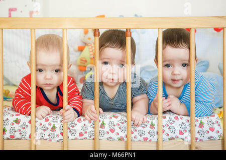 Portrait of  newborn triplets in the bed Stock Photo