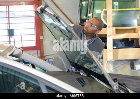 Mechanic fitting new windshield Stock Photo