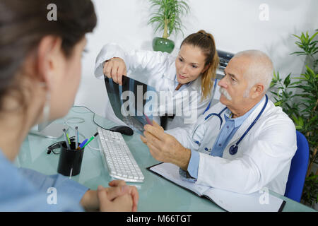 Two medical workers looking at xray Stock Photo