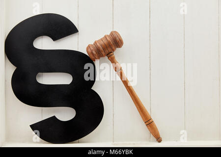 Paragraph and gavel as law and justice symbol in front of a wood background Stock Photo