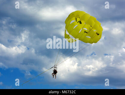 Parasailing on a yellow parachute Stock Photo