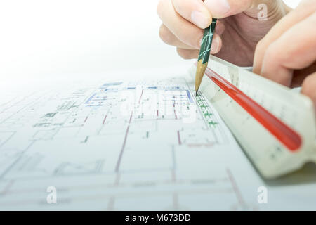 engineer are measuring distance in drawing using pencil and ruler Stock Photo