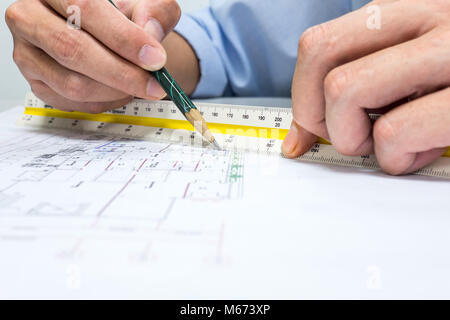 engineer are measuring distance in drawing using pencil and ruler Stock Photo