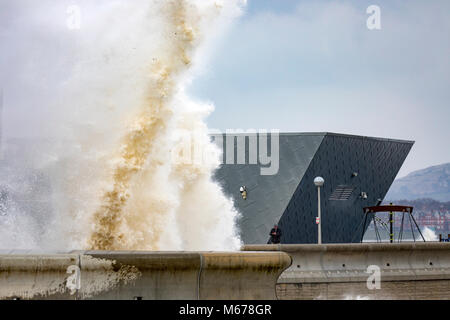 Colwyn Bay, UK UK Weather. The Beast from the East covers many parts of the UK with snow with further snowfall to arrive today with Met Office Red Warnings in place for snow and winds. Freezing temperatures and high winds bringing coastal flooding to the seafront at Colwyn Bay as huge waves crash into the coastal wall and Porth Eirias building on the promenade as a result of Storm Emma and the Beast from the East storm front Stock Photo