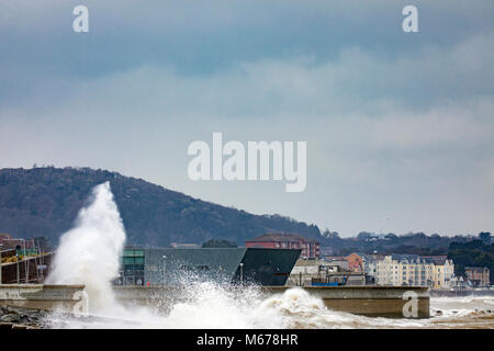 Colwyn Bay, UK UK Weather. The Beast from the East covers many parts of the UK with snow with further snowfall to arrive today with Met Office Red Warnings in place for snow and winds. Freezing temperatures and high winds bringing coastal flooding to the seafront at Colwyn Bay as huge waves crash into the coastal wall and Porth Eirias building on the promenade as a result of Storm Emma and the Beast from the East storm front Stock Photo