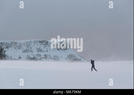 Edinburgh Scotland UK. 1st of March 2018. UK Weather. A woman is seen walking in the snow on top of Calton Hill in Edinburgh city center. Credit: Lorenzo Dalberto/Alamy Live News Stock Photo