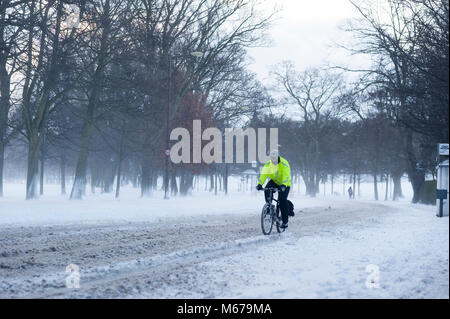 Edinburgh Scotland UK. 1st of March 2018. UK Weather. A man cycling on a road covered in snow in Edinburgh city center. Credit: Lorenzo Dalberto/Alamy Live News Stock Photo