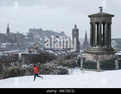 Edinburgh, Scotland, United Kingdom, 1 March, 2018. Heavy snowfalls continue across the city from the storm known as The Beast from the East. Most shops are closed and transport services have been cancelled. Pictured; Jogger runs through snow on Calton Hill Credit: Iain Masterton/Alamy Live News Stock Photo