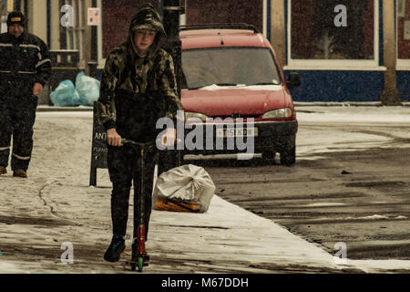 The Boy Rides A Snow Scooter From The Mountain In The Pure White Snow In Winter Stock Photo Alamy