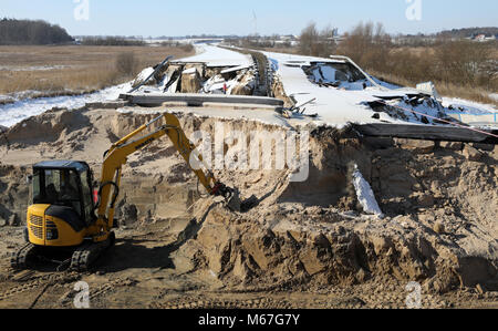 01 March 2018, Germany, Triebsees. An excavator removing earth from the sunken Baltic Sea autobahn A20. Federal Transportation Minister Schmidt has promised Mecklenburg-Western Pomerania comprehensive support with the repair work. Unterstützung bei der Reparatur zugesagt. The A20 is completely shut down since end of October 2017 after collapses in the road's surface. Photo: Bernd Wüstneck/dpa Stock Photo