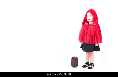 Halloween. Little Red Riding Hood. Beautiful little girl in a red raincoat with a hood. Stock Photo