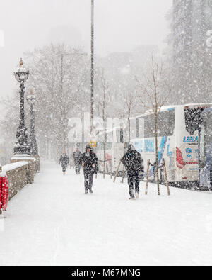 London, UK; 28th February 2018; Pedestrians Walking on Pavement through Snowstorm Stock Photo