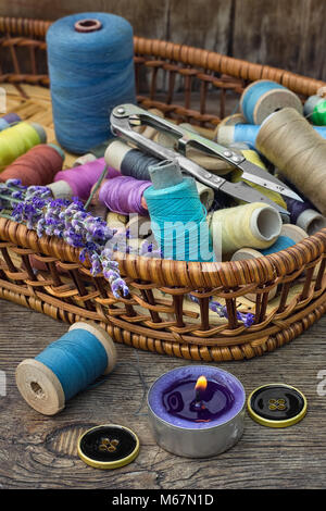 Basket with spools of thread and buttons and fresh lavender. Stock Photo