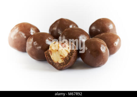 Chocolate balls filled with hazelnuts isolated on white background Stock Photo