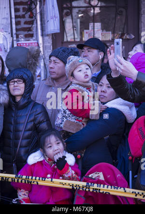 Chinese Americans come out to be entertained and participate in Chinese New Year celebrations in the Brooklyn, New York Chinatown in Sunset Park Brooklyn. Stock Photo